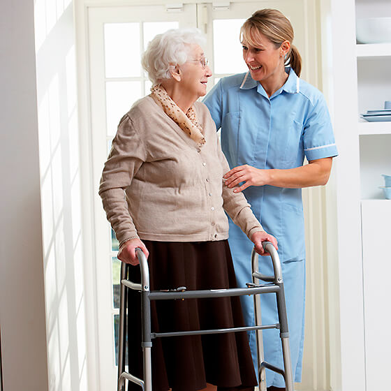 A caregiver and a senior resident talking together